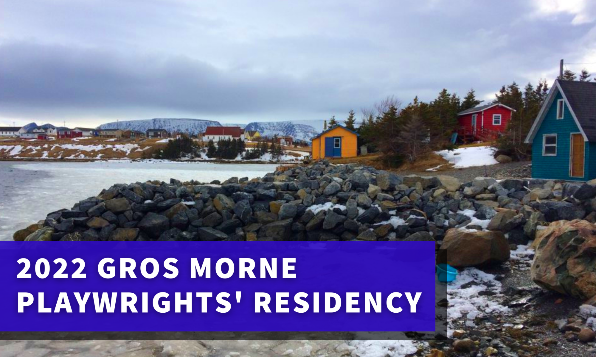 Image of a shoreline in Gros Morne featuring colourful salt box houses. The image has a blue banner with white text which reads: “2022 Gros Morne Playwrights’ Residency”